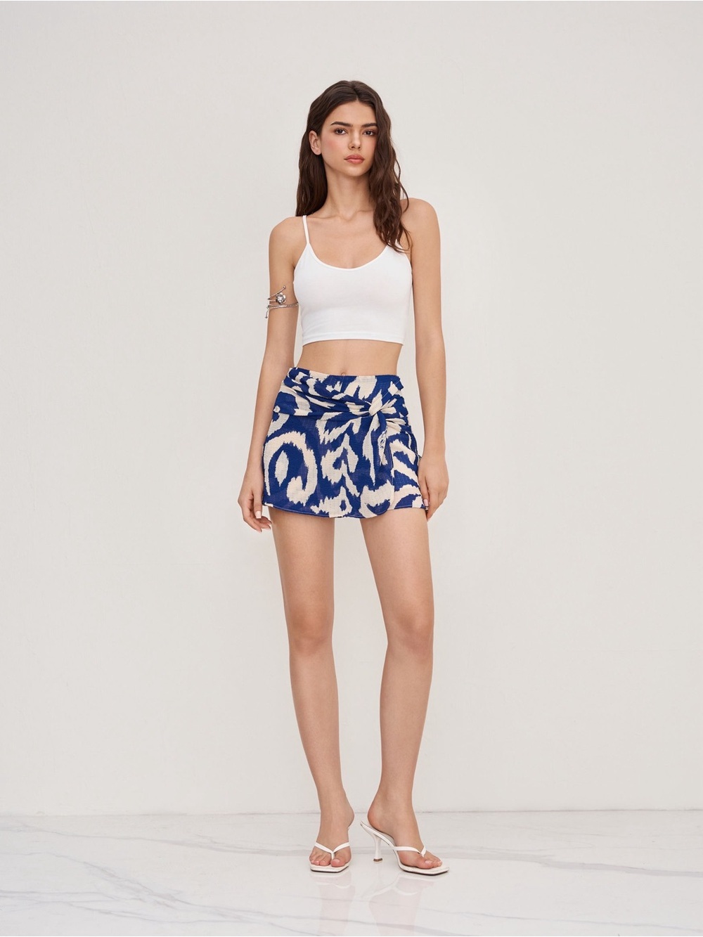 Cider round neckline crop top cami with mid rise abstract knotted mini skort L/8